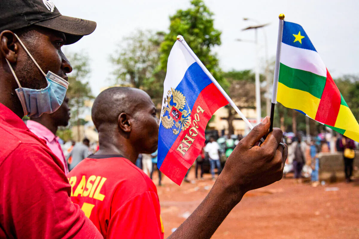 Russian and Central African Republic flags are waved by demonstrators gathered in Bangui on March 5, 2022 during a rally in support of Russia. (Photo by Carol Valade/AFP via Getty Images)