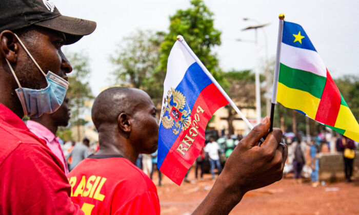 Russian and Central African Republic flags are waved by demonstrators gathered in Bangui on March 5, 2022 during a rally in support of Russia. (Photo by Carol Valade/AFP via Getty Images)