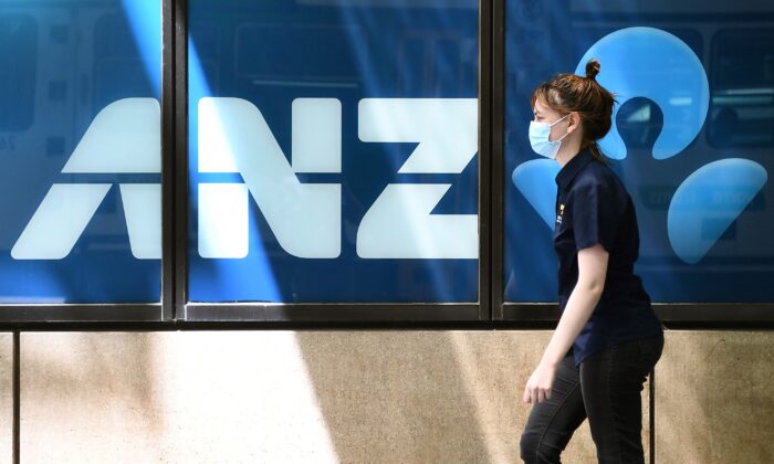 A woman walks past an ANZ Bank in Melbourne on October 28, 2021. (William West/AFP via Getty Images)