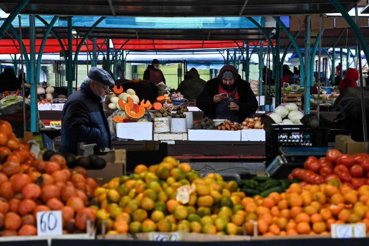 A man walks past vegetable stalls at a market in Moscow, Russia on Dec. 15, 2021. (Kirill Kudryavtsev/AFP via Getty Images)