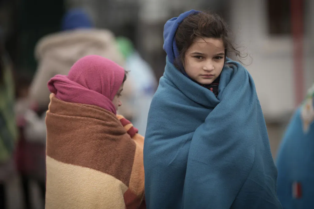 Refugee children fleeing Ukraine are given blankets by Slovakian rescue workers to keep warm at the Velke Slemence border crossing in Velke Slemence, Slovakia, on March 9, 2022. (Christopher Furlong/Getty Images)