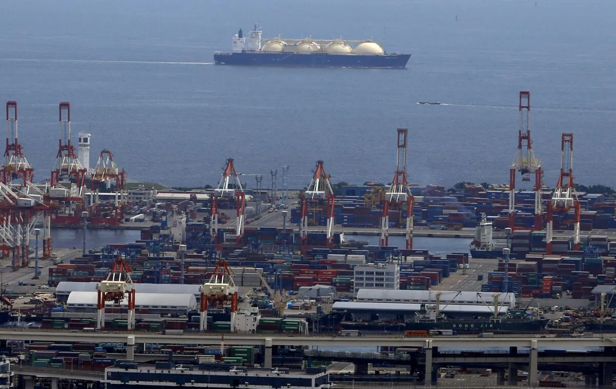 A LNG (Liquefied Natural Gas) tanker is seen behind a port in Yokohama, south of Tokyo, on Sept. 4, 2015. (Yuya Shino/Reuters)