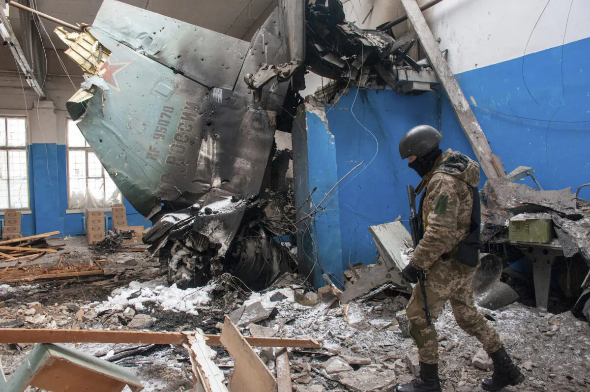A Ukrainian serviceman walks past the vertical tail fin of a Russian Su-34 bomber lying in a damaged building in Kharkiv, Ukraine, on March 8, 2022. (Andrew Marienko/AP Photo)