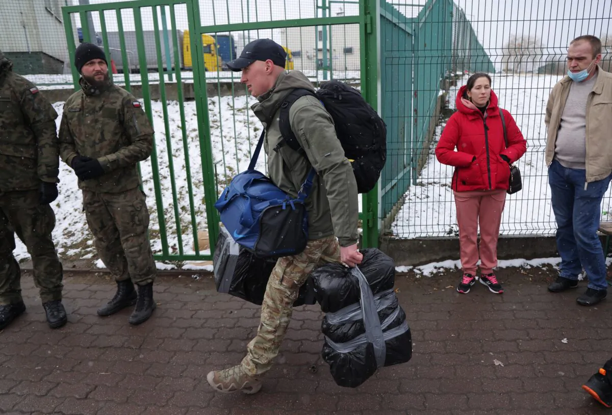 A man who said he wants to join the fight against the Russian army in Ukraine crosses into Ukraine at the Medyka border crossing, in Medyka, Poland, on March 9, 2022. (Sean Gallup/Getty Images)