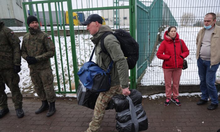 A man who said he wants to join the fight against the Russian army in Ukraine crosses into Ukraine at the Medyka border crossing, in Medyka, Poland, on March 9, 2022. (Sean Gallup/Getty Images)