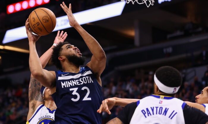 Minnesota Timberwolves center Karl-Anthony Towns (32) shoots the ball as Golden State Warriors guard Gary Payton II (0) guards him during the fourth quarter at Target Center in Minneapolis, Minn., on Mar 1, 2022. (Harrison Barden/USA TODAY Sports via Field Level Media)