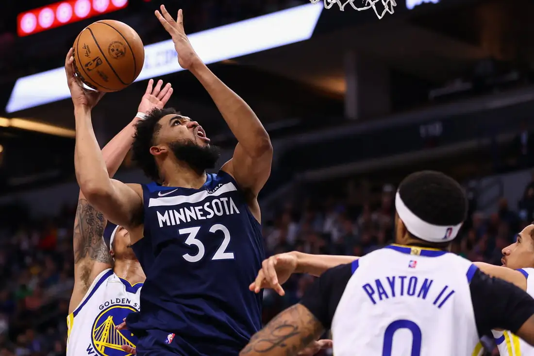 Minnesota Timberwolves center Karl-Anthony Towns (32) shoots the ball as Golden State Warriors guard Gary Payton II (0) guards him during the fourth quarter at Target Center in Minneapolis, Minn., on Mar 1, 2022. (Harrison Barden/USA TODAY Sports via Field Level Media)