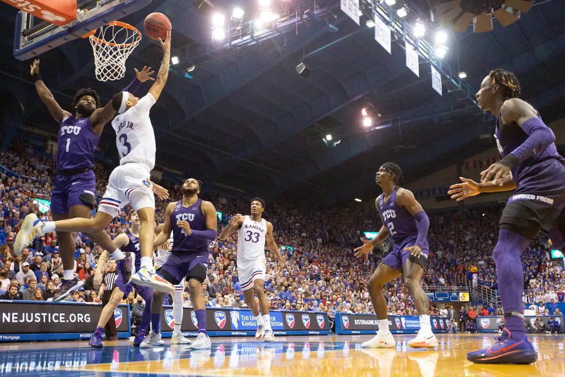 Kansas redshirt sophomore guard Dajuan Harris Jr. (3) scores under the basket in the second half of Thursday's game against TCU inside Allen Fieldhouse, on March 3, 2022. (Evert Nelson/The Capital-Journal/USA TODAY NETWORK via Field Level Media)