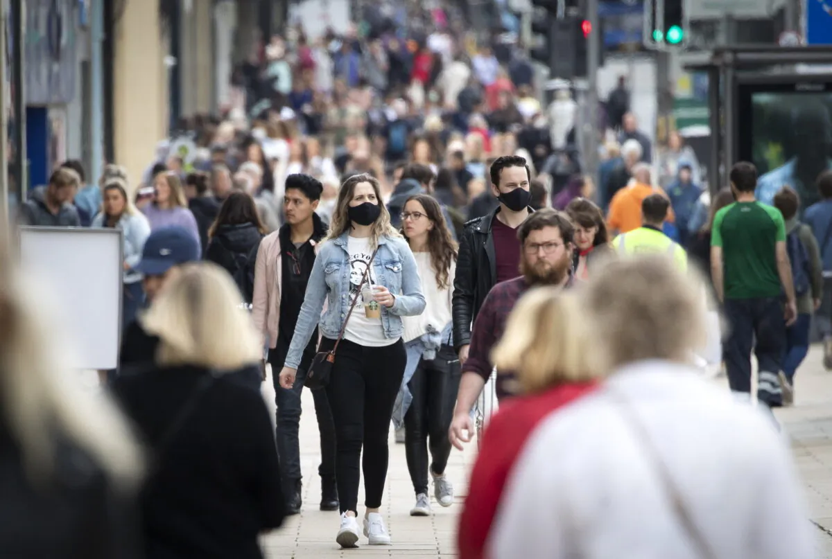 Undated file photo showing crowds of people waking in a street. (Jane Barlow/PA)