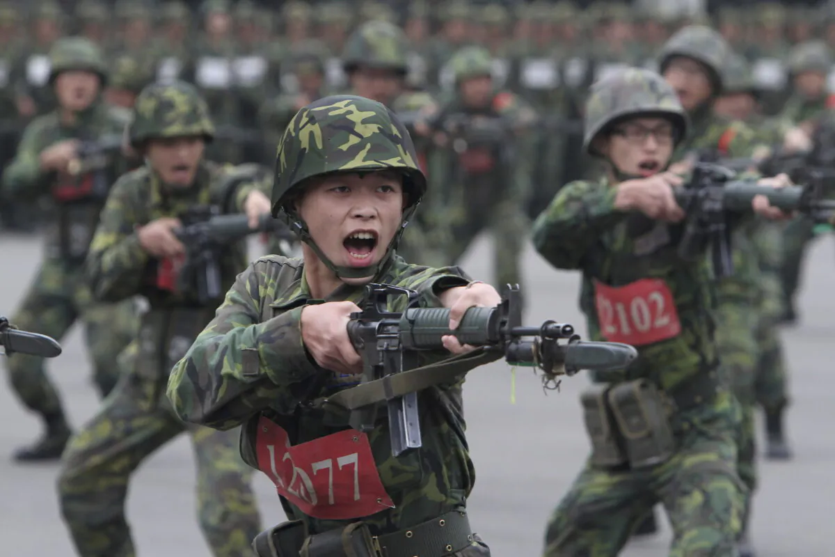 New recruits practice charging with bayonets at a military training center in Hsinchu County, northern Taiwan, on April 22, 2013. (Chiang Ying-ying/AP Photo)