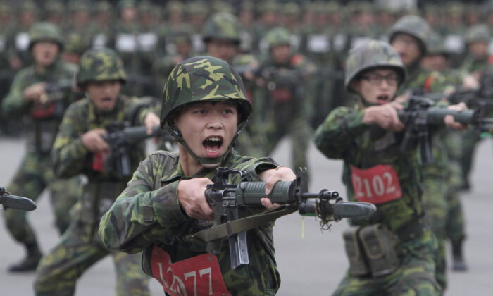 New recruits practice charging with bayonets at a military training center in Hsinchu County, northern Taiwan, on April 22, 2013. (Chiang Ying-ying/AP Photo)