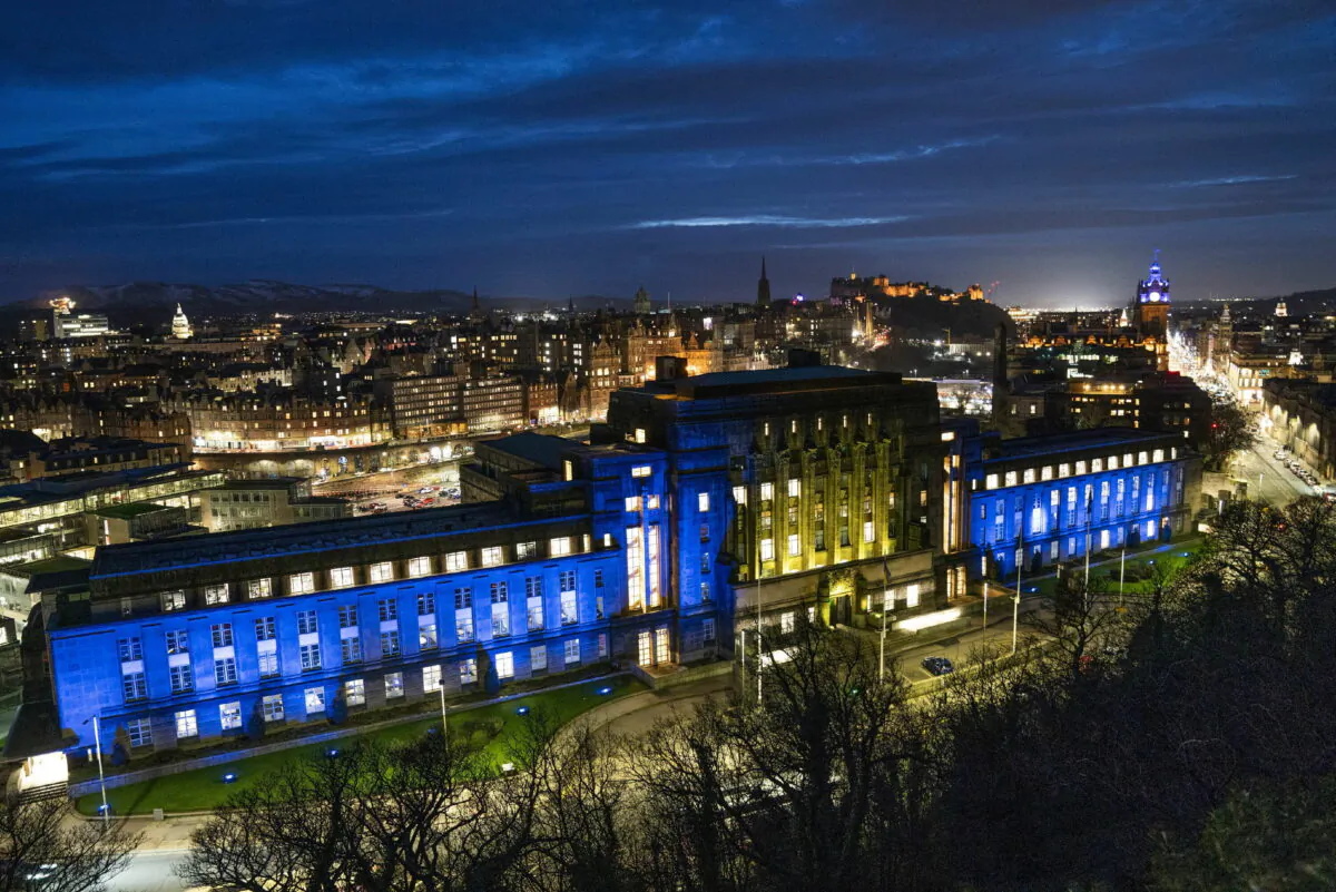 St Andrew's House in Edinburgh, Scotland, is lit up with the colors of the Ukraine flag on Feb. 25, 2022. (Jane Barlow/PA via AP)