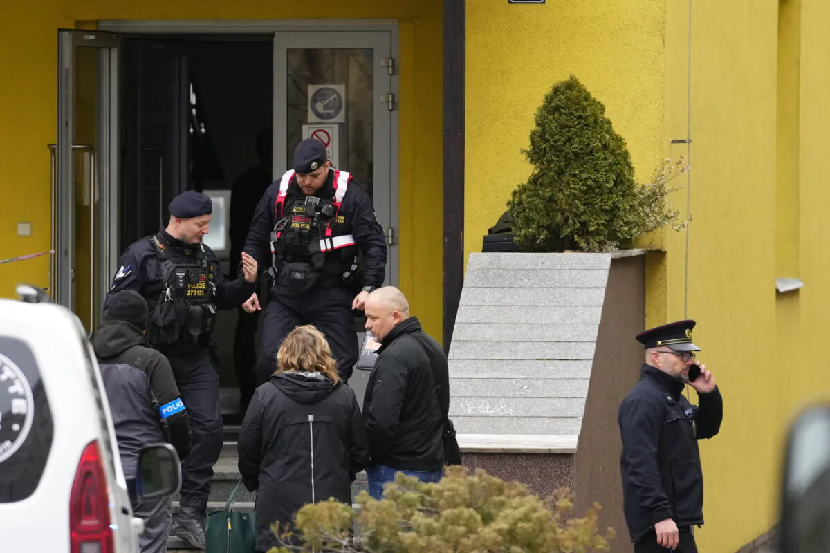 Members of Czech police forces stand in front of a school where a teacher was killed in Prague, Czech Republic, on March 31, 2022. (Petr David Josek/AP Photo)