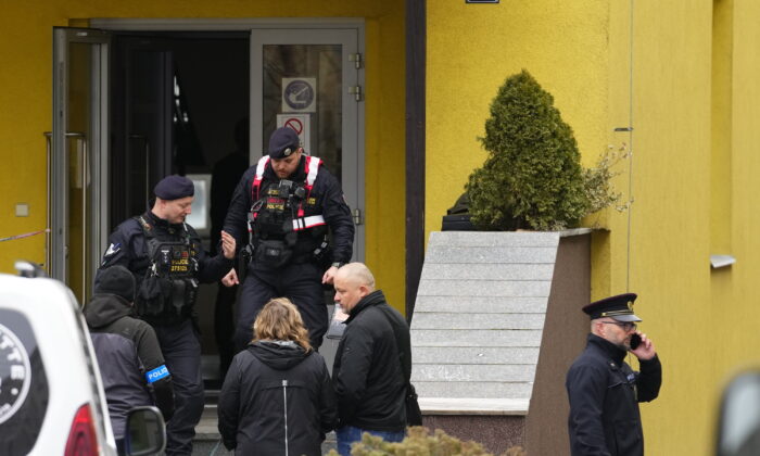 Members of Czech police forces stand in front of a school where a teacher was killed in Prague, Czech Republic, on March 31, 2022. (Petr David Josek/AP Photo)