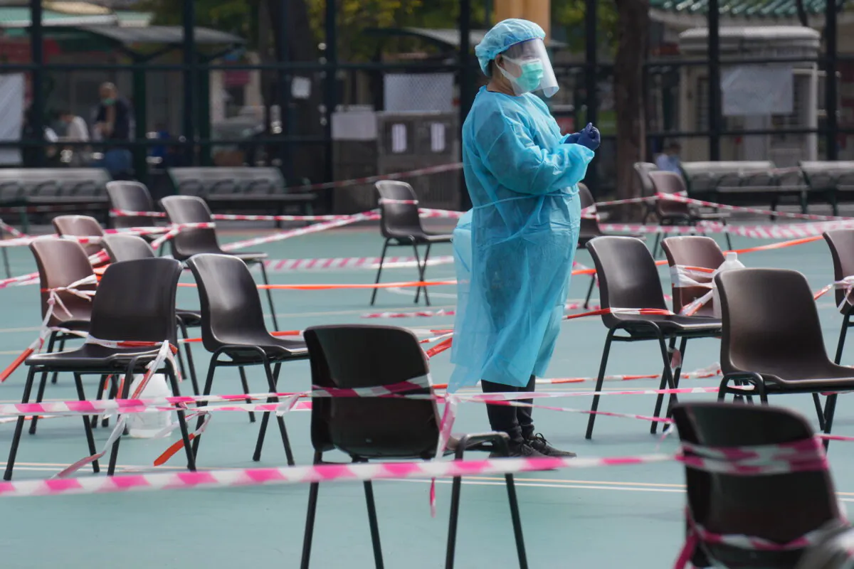 A health worker waits for residents to be tested for the Coronavirus at a testing center in Hong Kong on Feb. 28, 2022. (Vincent Yu/AP Photo)