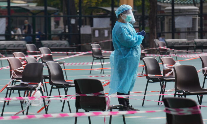A health worker waits for residents to be tested for the Coronavirus at a testing center in Hong Kong on Feb. 28, 2022. (Vincent Yu/AP Photo)