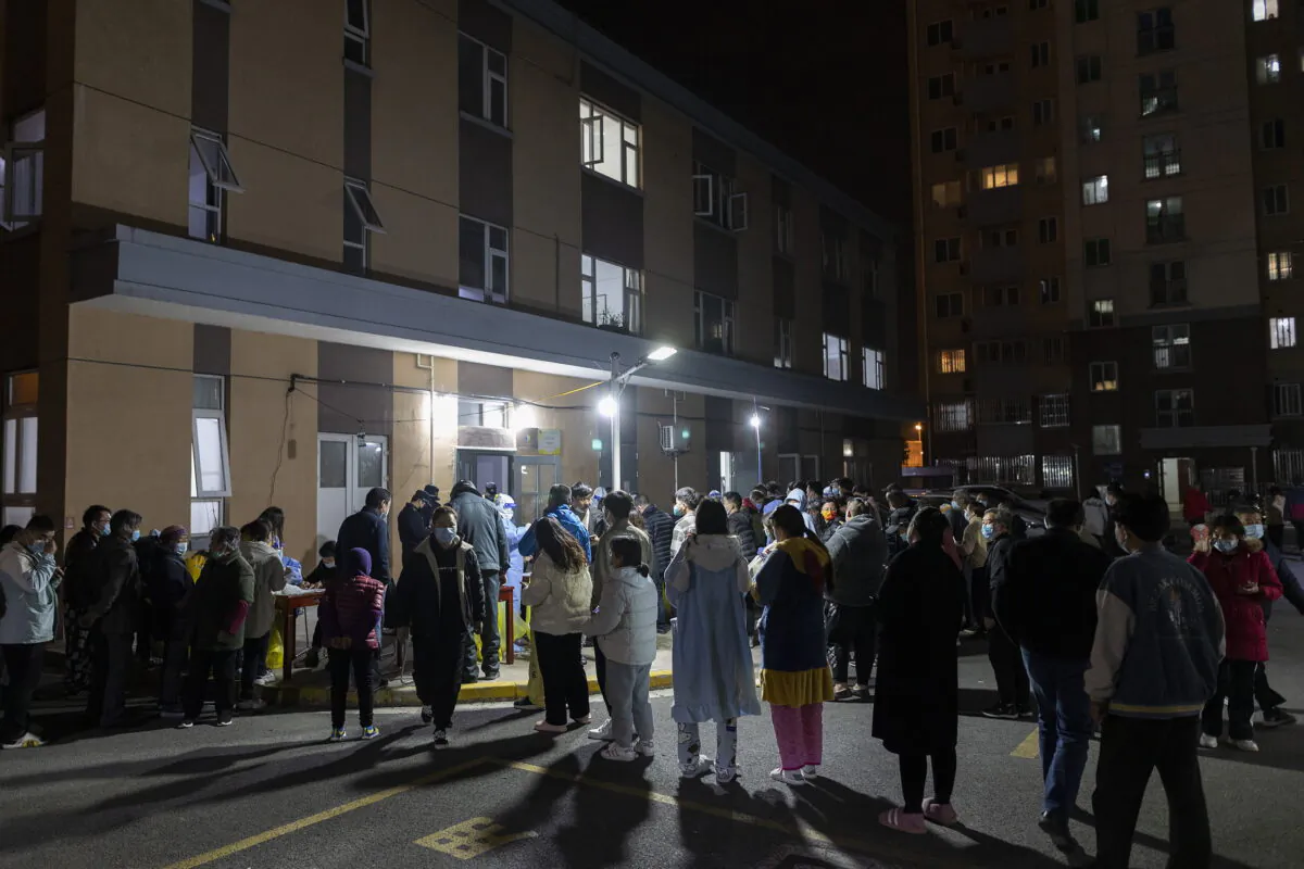 People line up for coronavirus tests as part of mass COVID-19 testing in a residential community in Shanghai, on March 10, 2022. China is tackling a COVID-19 spike with selective lockdowns and other measures that are part of its draconian "zero tolerance" strategy. (AP Photo)