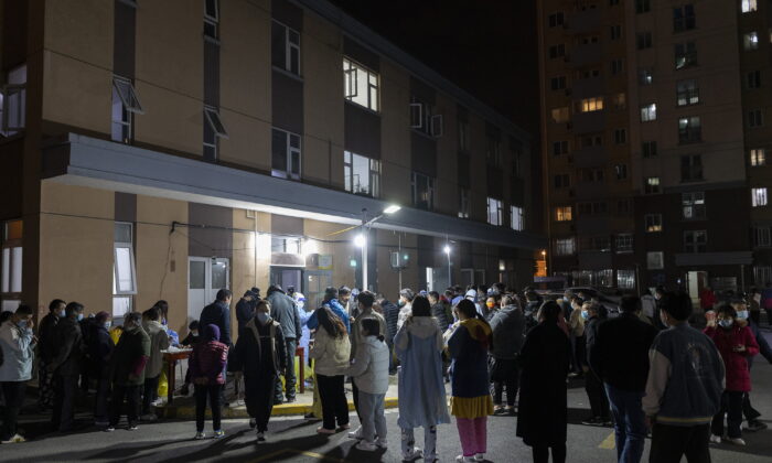 People line up for coronavirus tests as part of mass COVID-19 testing in a residential community in Shanghai, on March 10, 2022. China is tackling a COVID-19 spike with selective lockdowns and other measures that are part of its draconian "zero tolerance" strategy. (AP Photo)