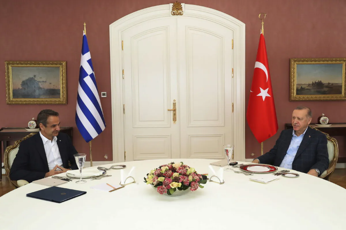 Greek Prime Minister Kyriakos Mitsotakis, left, talks to Turkish President Recep Tayyip Erdogan during their meeting in Istanbul, on March 13, 2022. (Turkish Presidency via AP)