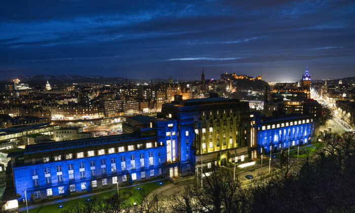 St Andrew's House in Edinburgh, Scotland, is lit up with the colors of the Ukraine flag on Feb. 25, 2022. (Jane Barlow/PA via AP)