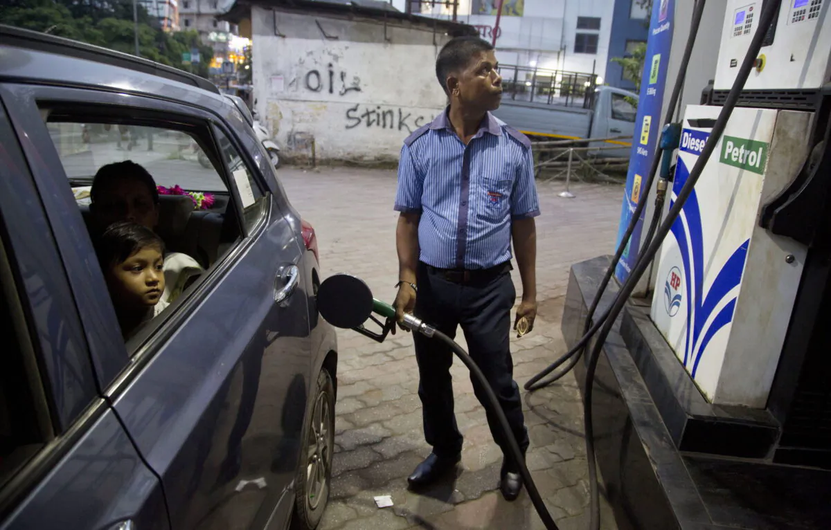 A man fills a car at a gasoline station in Gauhati, India, on Sept. 22, 2019. The state-run Indian Oil Corp. bought 3 million barrels of crude oil from Russia earlier this month to secure its energy needs, resisting Western pressure to avoid such purchases, an Indian government official said March 18, 2022. (AP Photo/Anupam Nath)