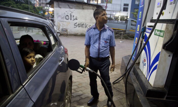 A man fills a car at a gasoline station in Gauhati, India, on Sept. 22, 2019. The state-run Indian Oil Corp. bought 3 million barrels of crude oil from Russia earlier this month to secure its energy needs, resisting Western pressure to avoid such purchases, an Indian government official said March 18, 2022. (AP Photo/Anupam Nath)