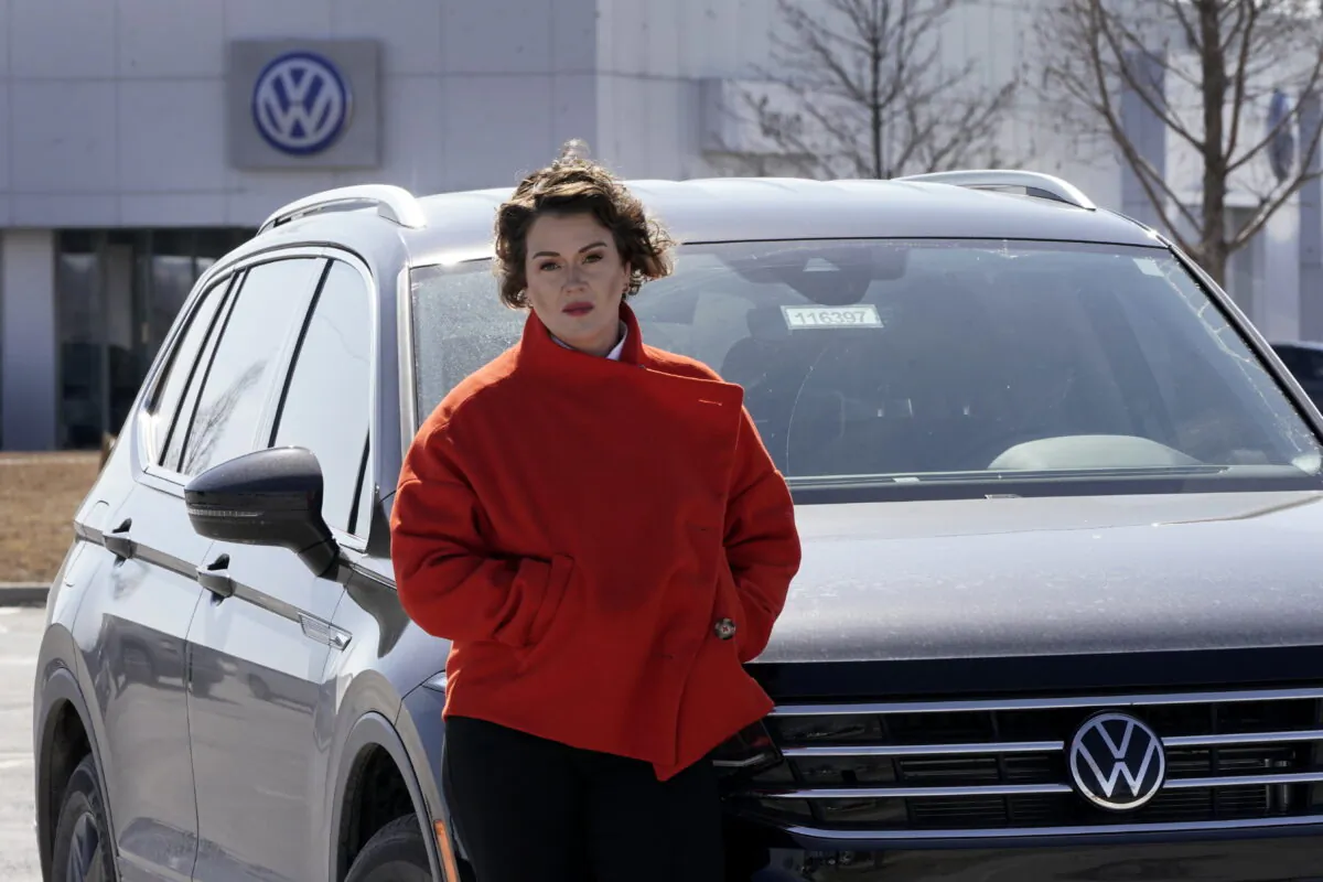 Kendall Heiman stands with the loner car she has driven for the past two months in Lawrence, Kan., on March 9, 2022. (Charlie Riedel/AP Photo)