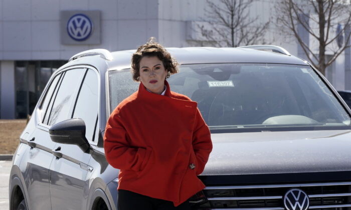 Kendall Heiman stands with the loner car she has driven for the past two months in Lawrence, Kan., on March 9, 2022. (Charlie Riedel/AP Photo)