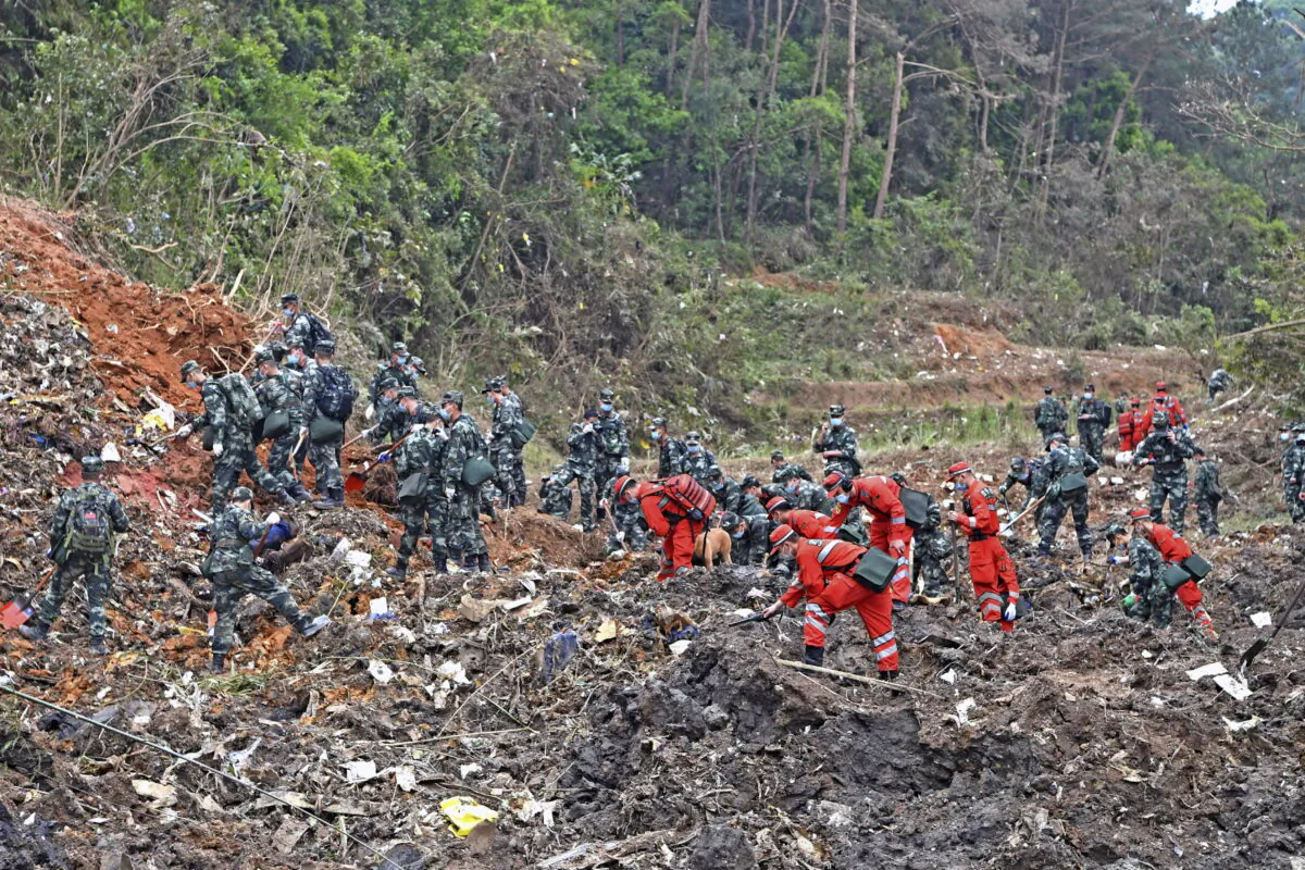 Rescue workers search for the black boxes after a China Eastern flight 5735 carrying 123 passengers and 9 crew members crashed outside the city of Wuzhou, Guangxi Province, on March 22, 2022. (Zhou Hua/Xinhua via AP)