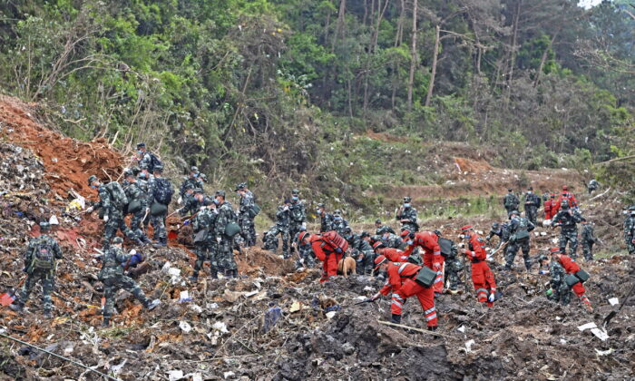 Rescue workers search for the black boxes after a China Eastern flight 5735 carrying 123 passengers and 9 crew members crashed outside the city of Wuzhou, Guangxi Province, on March 22, 2022. (Zhou Hua/Xinhua via AP)