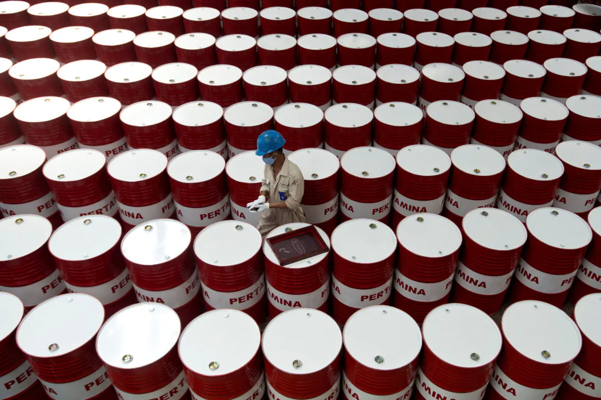 A worker prepares to label barrels of lubricant oil at the state oil company Pertamina's lubricant production facility in Cilacap, Central Java, Indonesia, on Nov. 6, 2017. (Antara Foto/Rosa Panggabean/via Reuters)