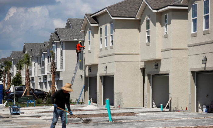 A carpenter works on building new townhomes while building material supplies are in high demand in Tampa, Fla., on May 5, 2021. (Octavio Jones/Reuters)
