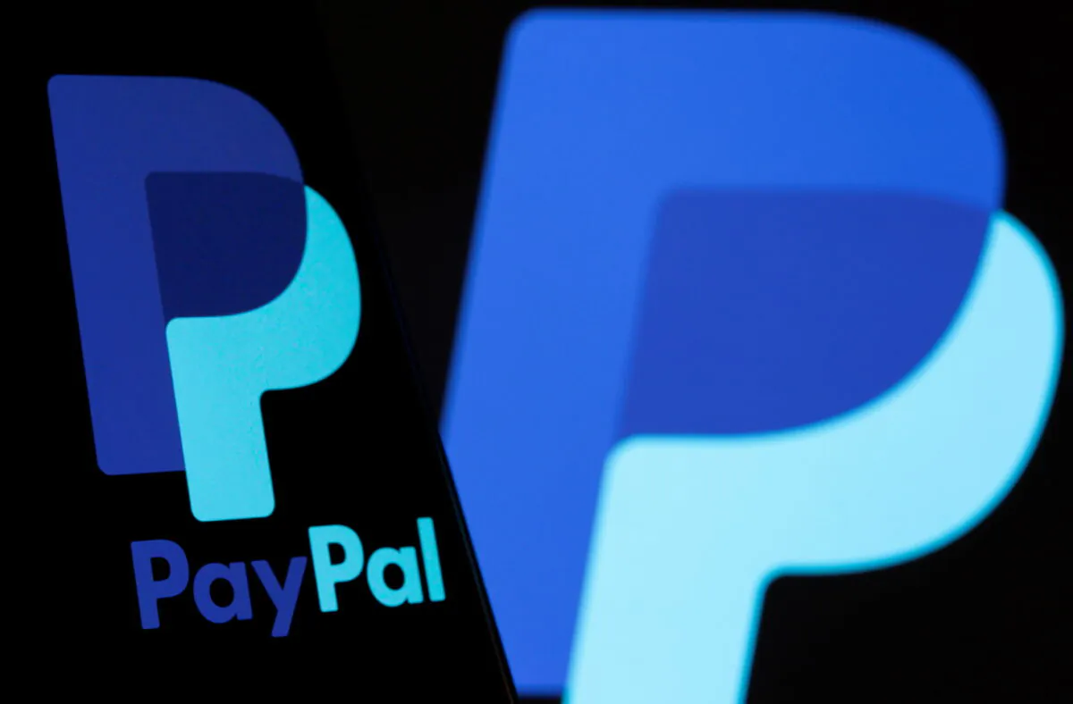 The PayPal logo on a smartphone in front of the same logo displayed in this illustration taken on Sept. 8, 2021. (Dado Ruvic/Reuters)