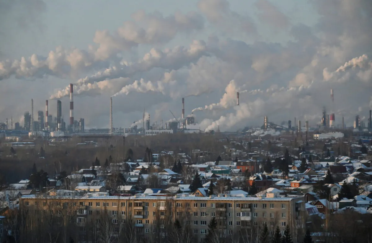 A general view shows a local oil refinery behind residential buildings in Omsk, Russia, on Feb. 10, 2021. (Alexey Malgavko/Reuters)