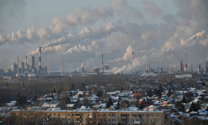A general view shows a local oil refinery behind residential buildings in Omsk, Russia, on Feb. 10, 2021. (Alexey Malgavko/Reuters)