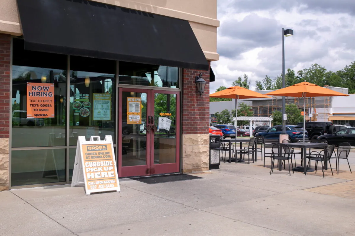 A hiring sign is seen in front of a Qdoba restaurant, as many restaurant businesses face staffing shortages in Louisville, Ky., on June 7, 2021. (Amira Karaoud/Reuters)