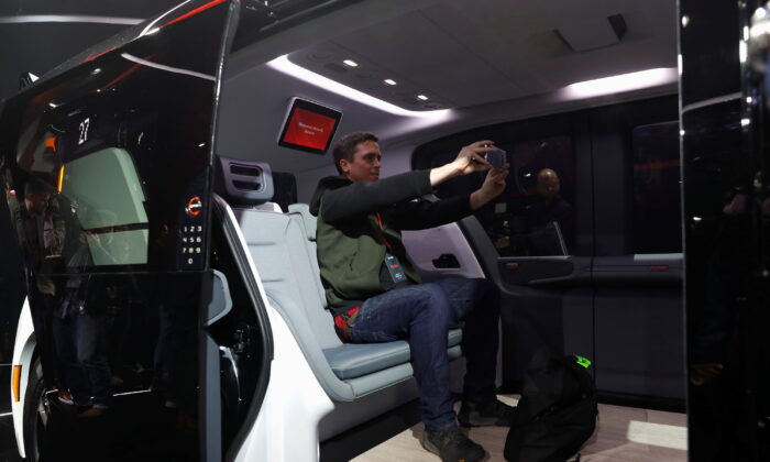An attendee takes a selfie inside a Cruise Origin autonomous vehicle, a Honda and General Motors self-driving car partnership, during its unveiling in San Francisco, on Jan. 21, 2020. (Stephen Lam/Reuters)