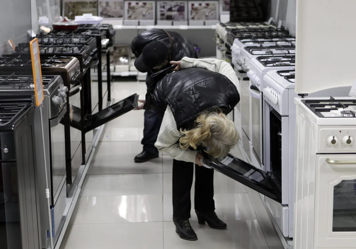 Customers inspect kitchen stoves at an electronic store in Stavropol, southern Russia, on Dec. 17, 2014. (Eduard Korniyenko/Reuters)