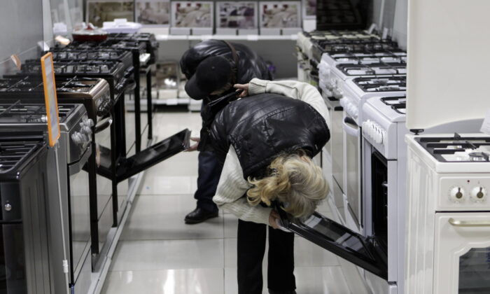 Customers inspect kitchen stoves at an electronic store in Stavropol, southern Russia, on Dec. 17, 2014. (Eduard Korniyenko/Reuters)