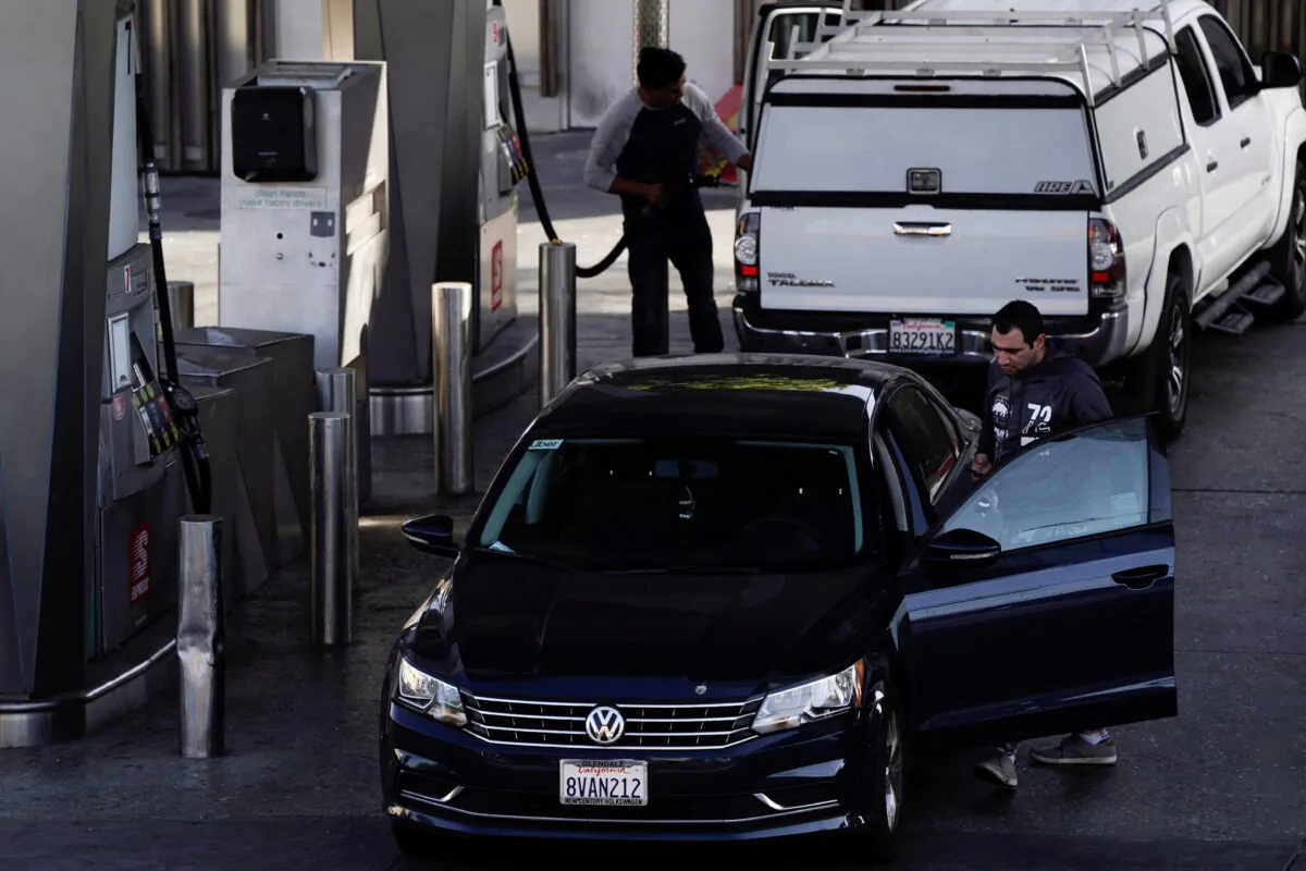 People refuel their vehicles with gasoline at the Helios House, the first LEED-certified gas station in the United States, in West Olympic Boulevard in Los Angeles on March 10, 2022. (Bing Guan/Reuters)