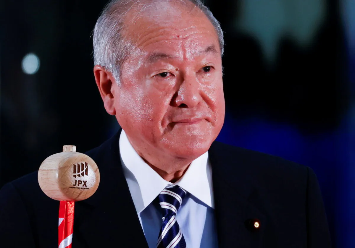 Japan's Finance Minister Shunichi Suzuki prepares to ring a bell during the New Year ceremony marking the opening of trading in 2022 at the Tokyo Stock Exchange (TSE), amid the coronavirus disease (COVID-19) pandemic, in Tokyo, Japan, on Jan. 4, 2022. (Issei Kato/Reuters)