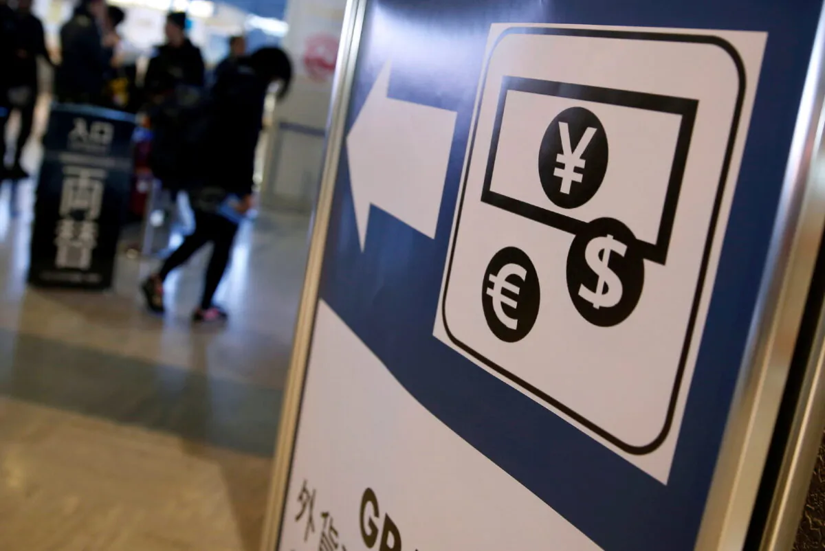 Currency signs of Japanese Yen, Euro, and the U.S. dollar are seen on a board outside a currency exchange office at Narita International airport, near Tokyo, Japan, on March 25, 2016. (Yuya Shino/Reuters)