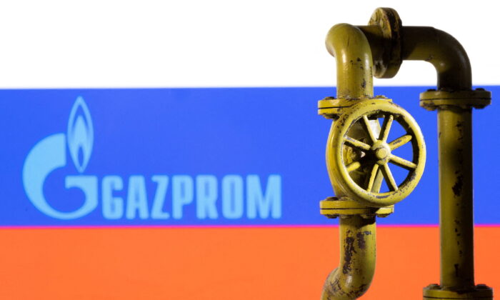 A 3D printed natural gas pipeline is placed in front of displayed Gazprom logo and Russian flag in this illustration taken on Feb. 8, 2022. (Dado Ruvic/Illustration/Reuters)
