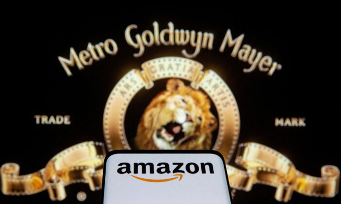 Smartphone with Amazon logo in front of displayed MGM logo in this illustration taken on May 26, 2021. (Dado Ruvic/Illustration/Reuters)