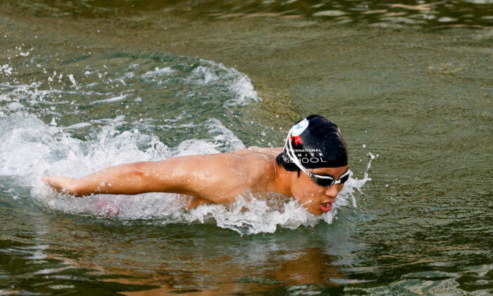 Competitive swimmer Jody Lee, 15, practices at Repulse Bay, in Hong Kong, on March 11, 2022. (Tyrone Siu/Reuters)