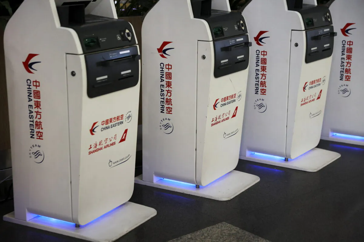 Logos of China Eastern Airlines are pictured on check-in kiosks at Beijing Capital International Airport in Beijing, China March 21, 2022. REUTERS/Tingshu Wang