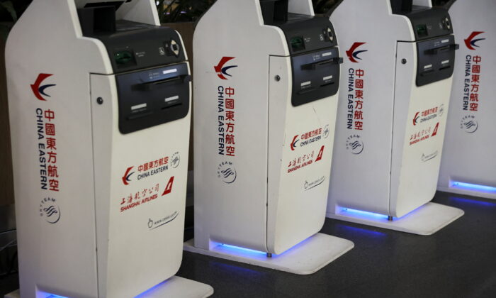 Logos of China Eastern Airlines are pictured on check-in kiosks at Beijing Capital International Airport in Beijing, China March 21, 2022. REUTERS/Tingshu Wang