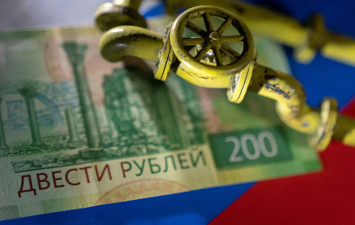A model of a natural gas pipeline is placed on a Russian rouble banknote and a flag in this illustration photo on March 23, 2022. (Dado Ruvic/Reuters)