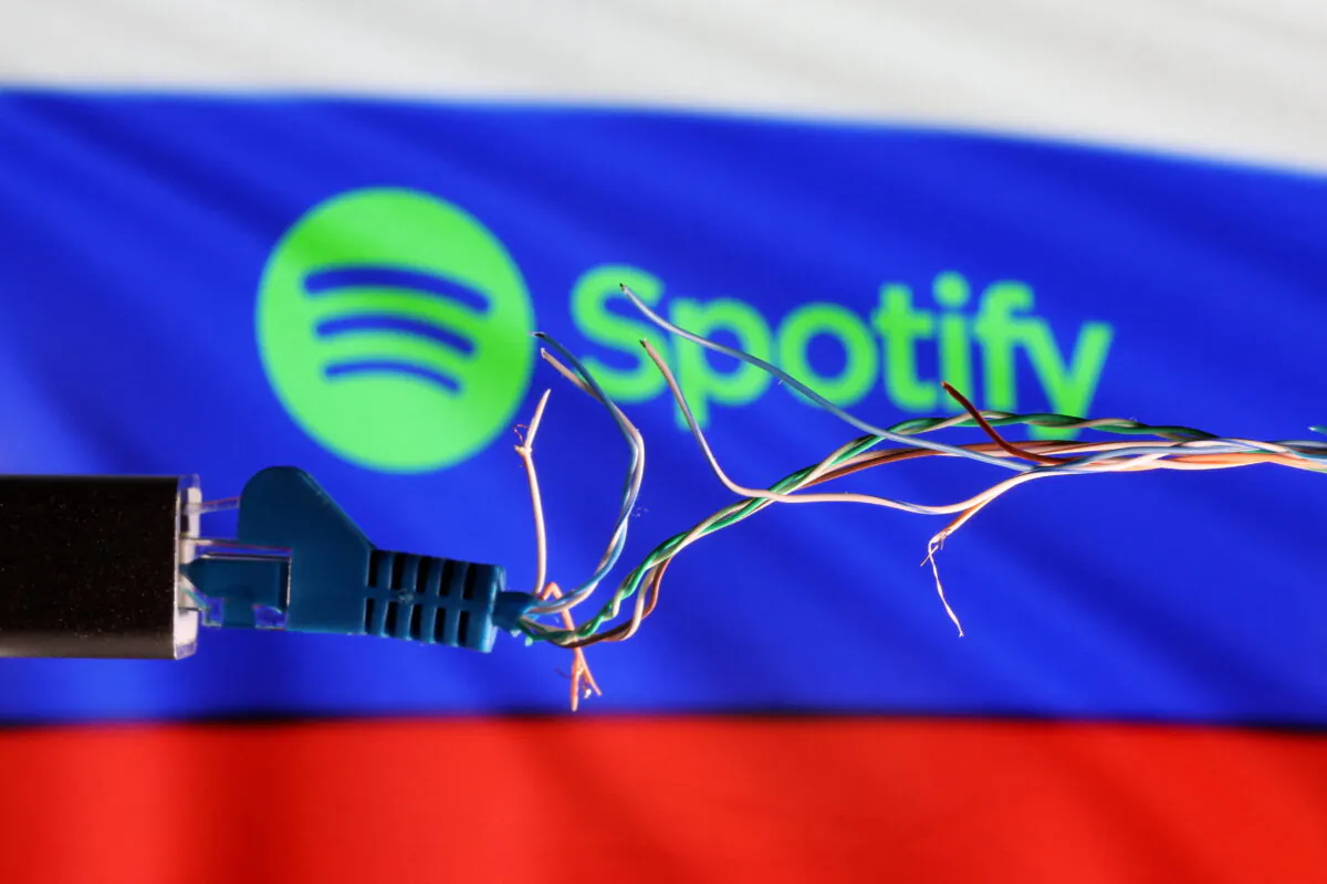 Broken Ethernet cable in front of Russian flag and Spotify logo in this illustration taken March 11, 2022. (Dado Ruvic/Reuters)