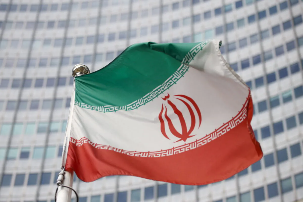 The Iranian flag waves in front of the International Atomic Energy Agency headquarters in Vienna on March 1, 2021. (Lisi Niesner/Reuters)